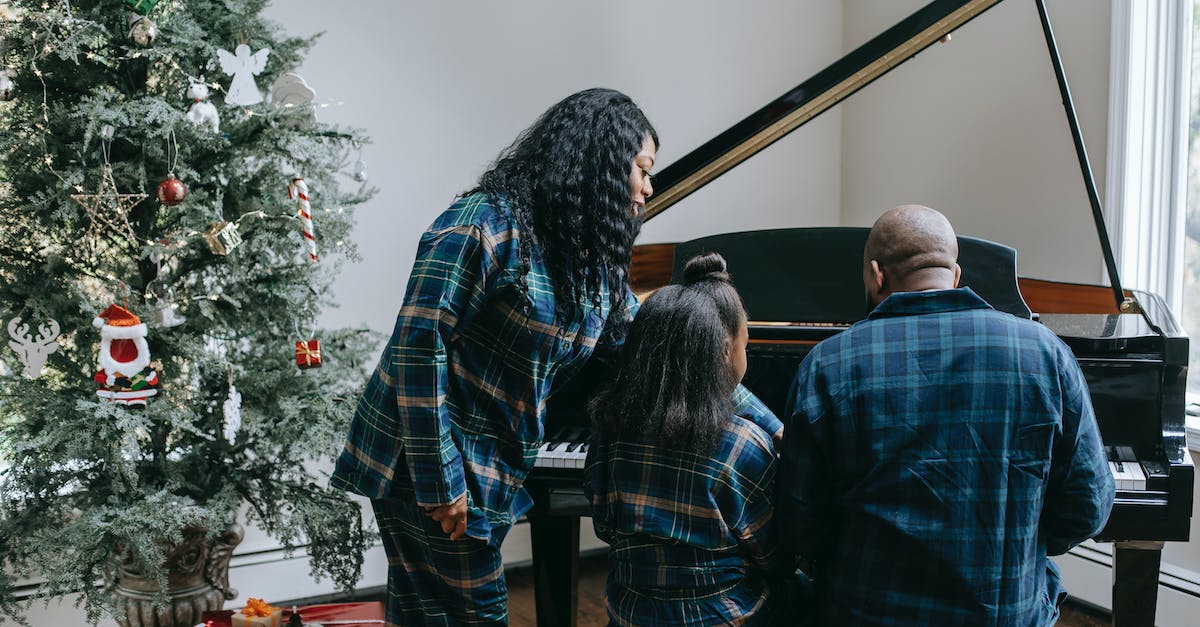 back-view-of-anonymous-african-american-family-playing-musical-instrument-in-cozy-room-with-decorate-1659521