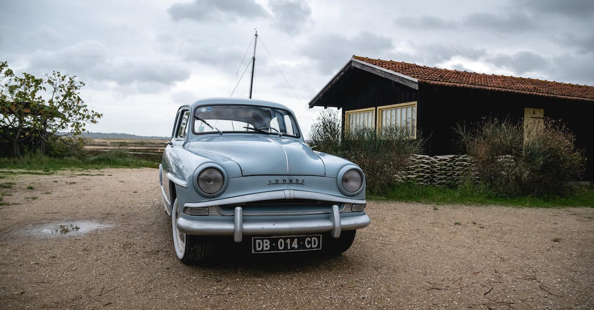 blue-mercedes-benz-coupe-parked-beside-brown-wooden-house-under-white-clouds-5554903