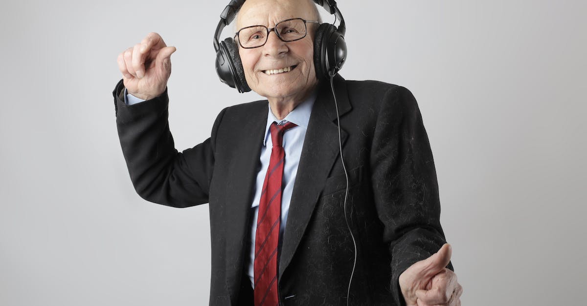 cheerful-elderly-man-listening-to-music-in-headphones-6440840