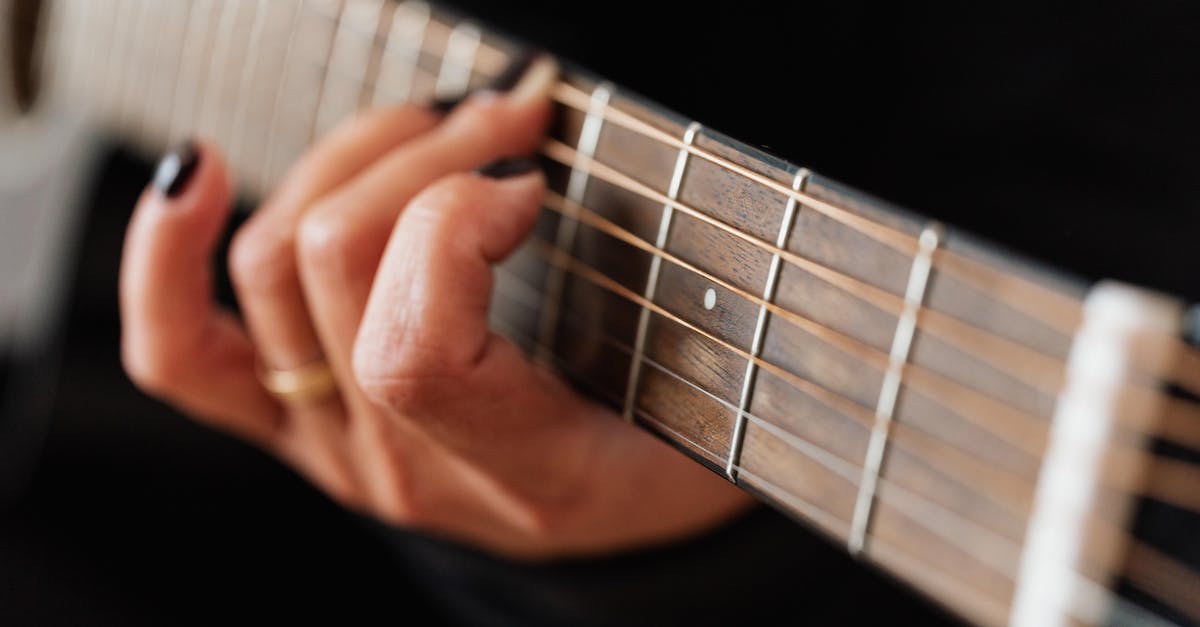 crop-faceless-woman-practicing-classical-guitar-technique-1324583