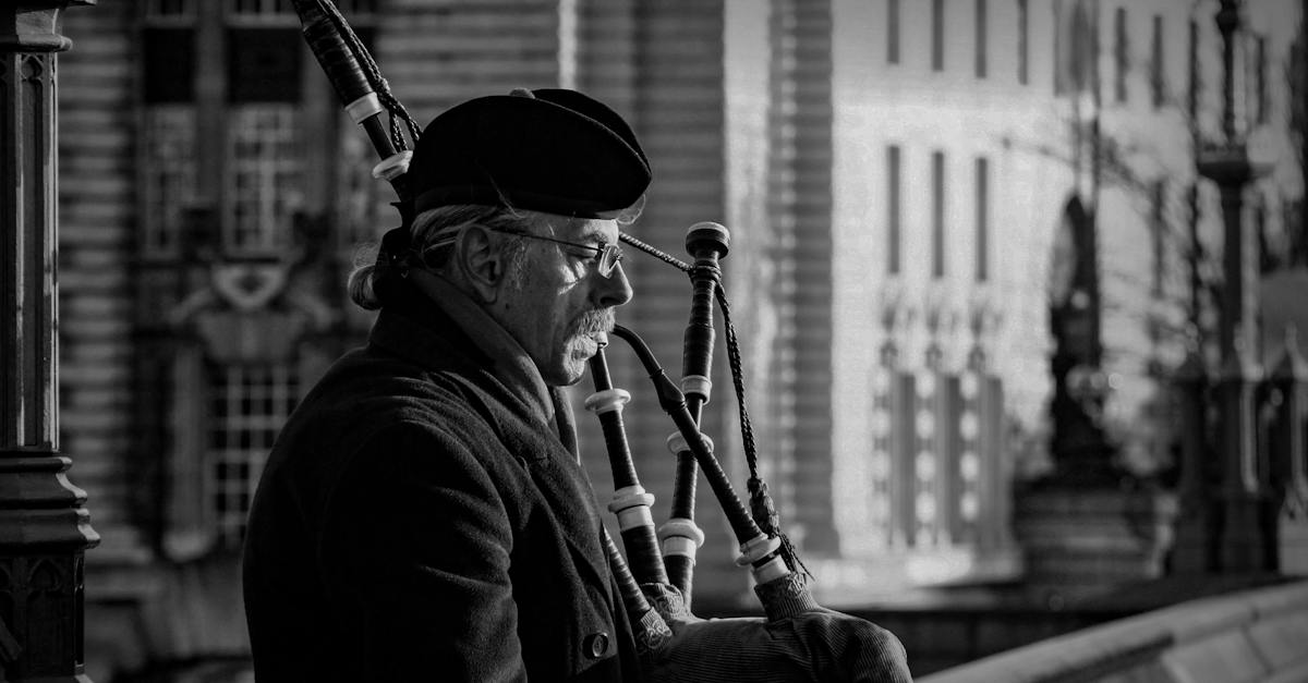 elderly-man-playing-a-bagpipe-in-grayscale-photography-7118256