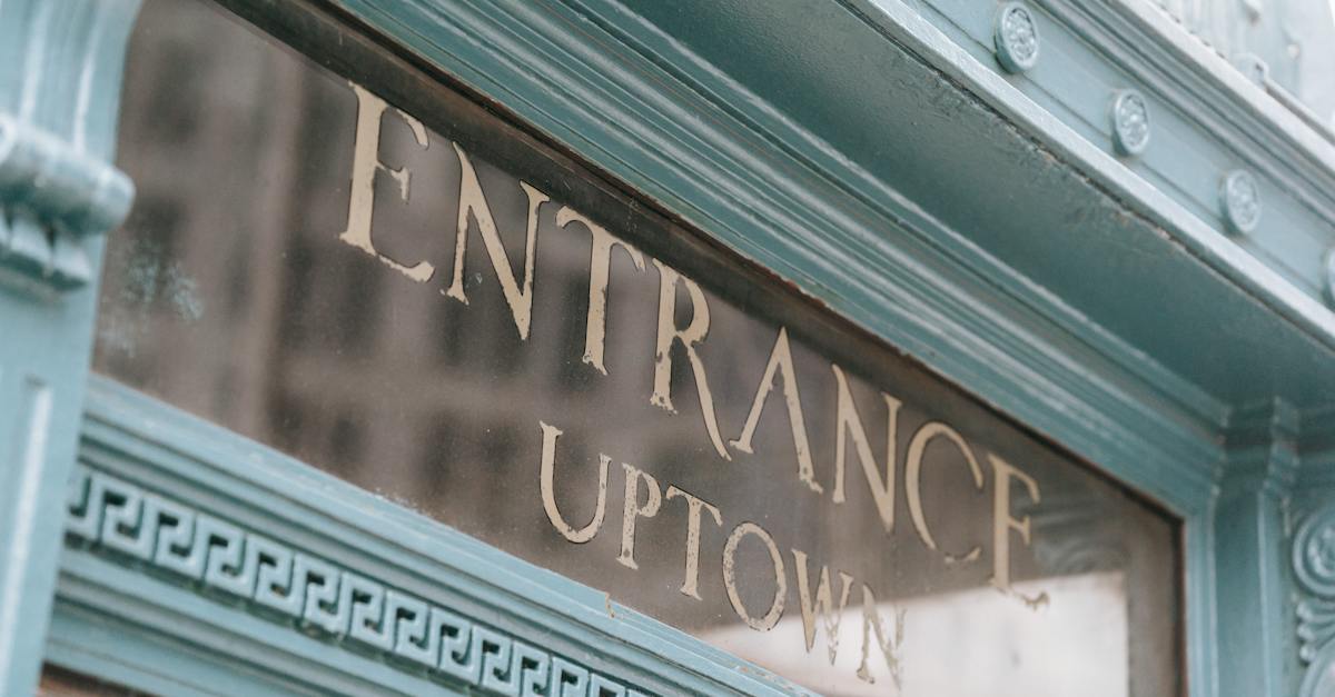 glass-signboard-with-inscription-placed-in-aged-fashioned-light-blue-facade-of-pub-on-street-in-dayl-8473411