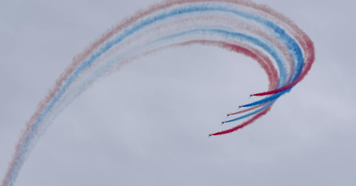 low-angle-of-aircrafts-in-row-creating-tricolor-air-tattoo-in-light-sky-on-national-aviation-day-1559637