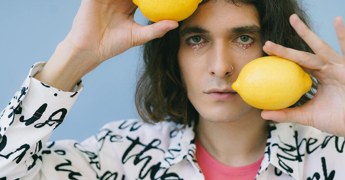 man-in-make-up-holding-lemons-8362174