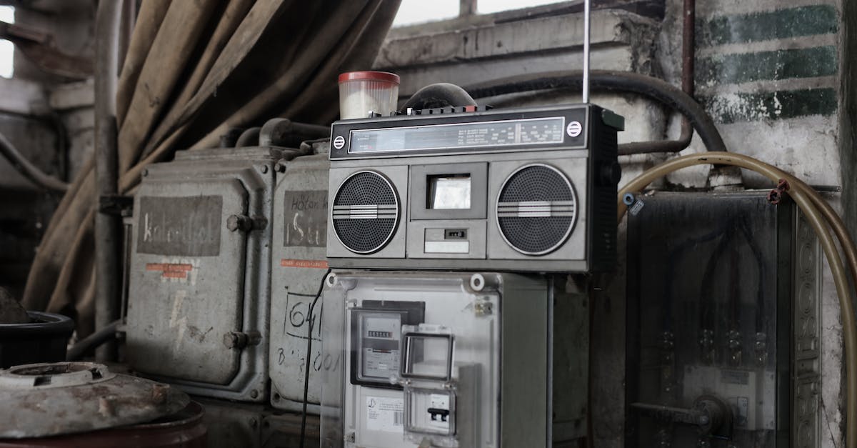 old-fashioned-cassette-player-placed-in-shabby-garage-near-old-industrial-equipment-3375795