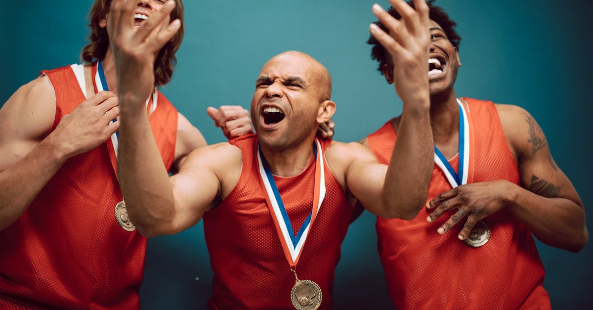 overjoyed-men-in-red-jerseys-wearing-their-medals-5999116