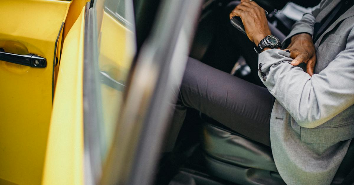 side-view-of-crop-anonymous-african-american-male-in-elegant-suit-checking-wristwatch-in-car-5918311