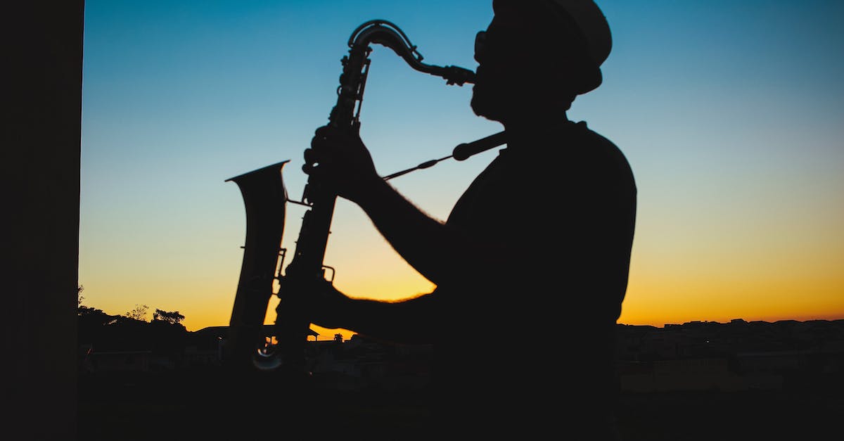 silhouette-of-a-man-playing-saxophone-during-sunset-2001145