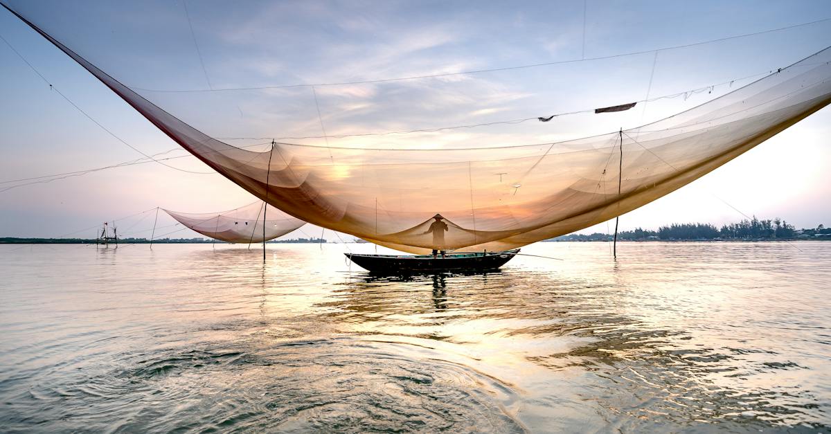 unrecognizable-man-near-fishing-net-on-sea-9477981