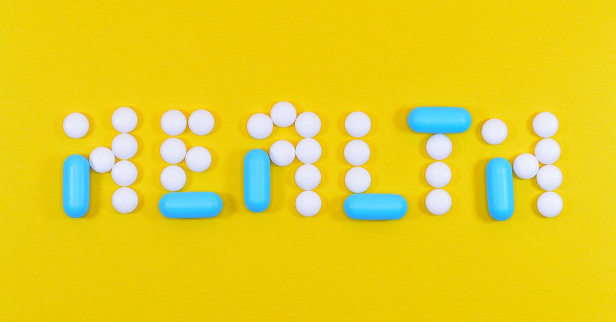 white-and-blue-health-pill-and-tablet-letter-cutout-on-yellow-surface-6727878