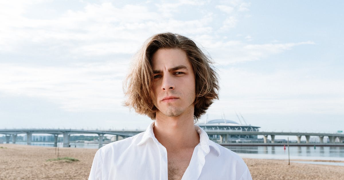 woman-in-white-button-up-shirt-standing-on-beach-8730661