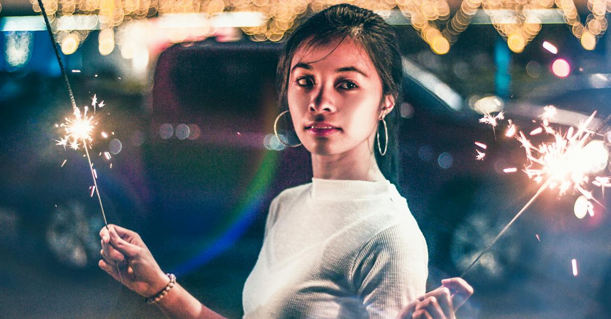 woman-in-white-crew-neck-shirt-standing-in-front-of-lighted-city-buildings-during-night-time-3831362