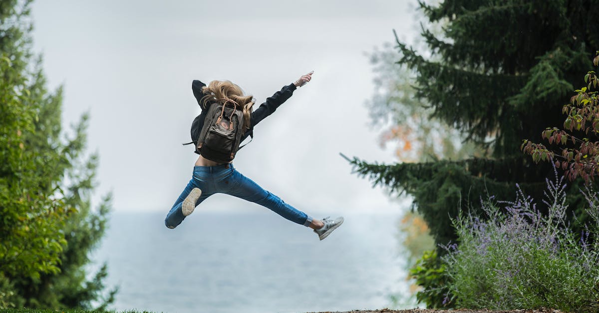 woman-jumping-wearing-green-backpack-6768894