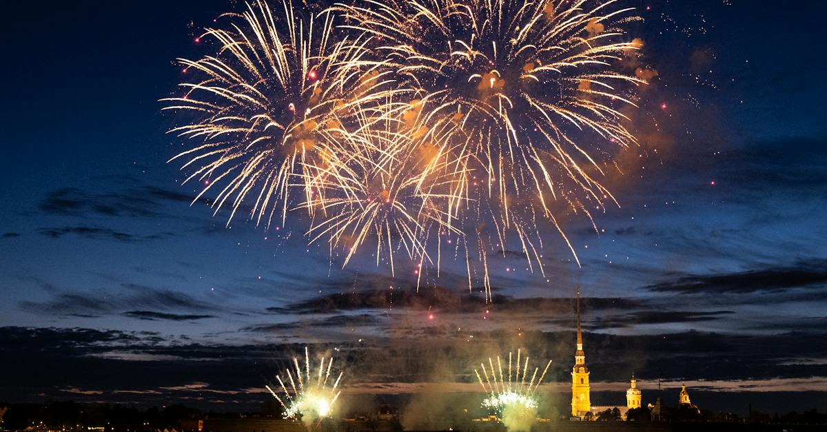 yellow-fireworks-on-a-waterfront-at-evening-and-dark-blue-sky-1541620